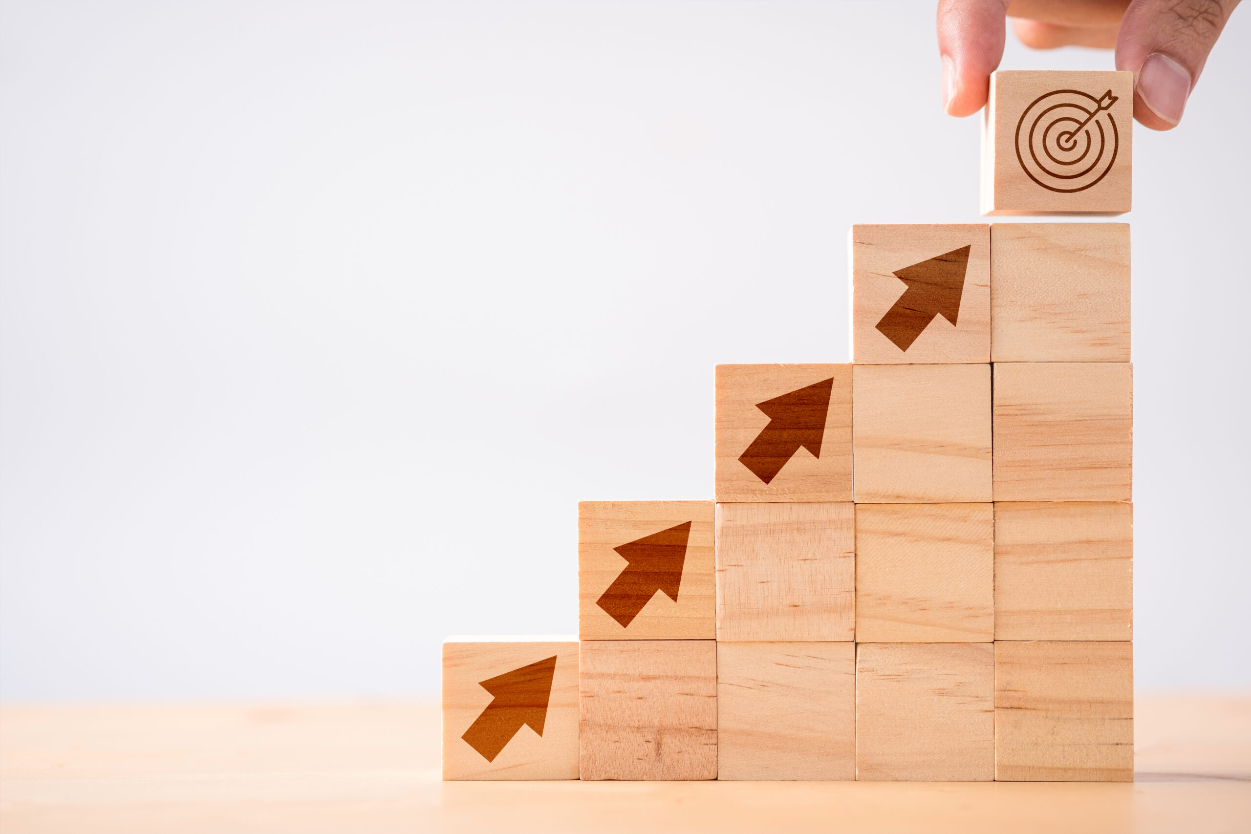 Hand putting Coins in glass jar with retro alarm clock